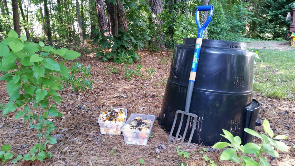 Materials used for composting, including a rain barrel, pitchfork and leftover produce, are collected together