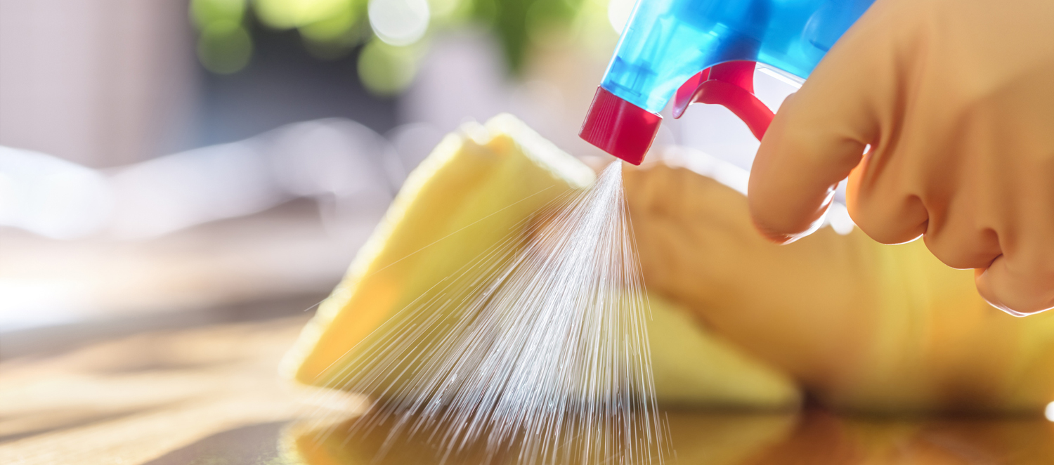 Cleaning with spray detergent, rubber gloves and dish cloth on work surface concept for hygiene